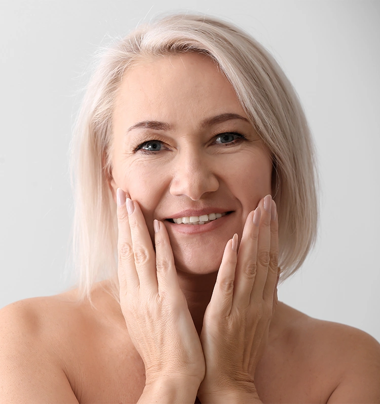 Mature woman touching with rejuvenated skin touching her face