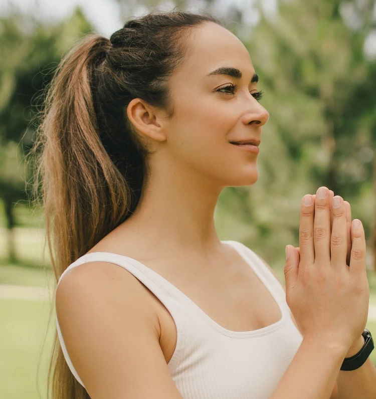 Woman doing yoga in the park with repaired earlobes